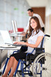 Foto: Businesswoman in wheelchair working in the office Businesswoman in wheelchair working in the office