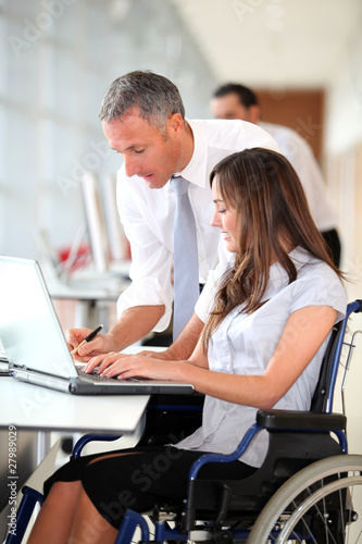 Photo: Manager and office worker in wheelchair Manager and office worker in wheelchair