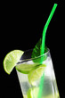 Photo: Mojito cocktail with fresh limes on a black background Mojito cocktail with fresh limes on a black background