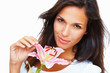 Brunette touching petal of stargazer lily Brunette touching petal of stargazer lily