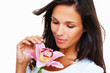 Brunette holding and looking at stargazer lily Brunette holding and looking at stargazer lily
