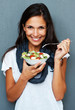 Woman smiling while holding bowl of salad Woman smiling while holding bowl of salad