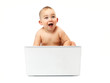 Surprised baby boy using a laptop computer
