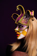 woman in violet half mask
