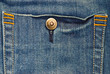 Macro blue jeans background with button