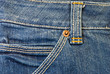 Macro blue jeans background with button
