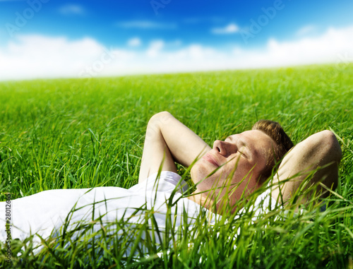 Photo: young man in spring grass young man in spring grass