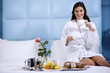Relaxed Woman Having Breakfast in Bed