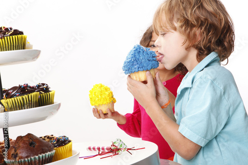 Photo: A couple of kids enjoy cupcakes A couple of kids enjoy cupcakes