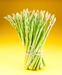 Sheaf of asparagus on a yellow background. Sheaf of asparagus on a yellow background.