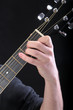 Human hand taking E-major accord at guitar Human hand taking E-major accord at guitar