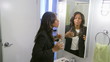 Young woman putting on makeup