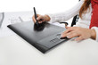 hand on graphic tablet. hand on graphic tablet.