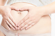 Pregnant caucasian mother with hands on belly