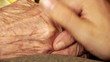 Senior old woman young man hold hand wrinkle skin close up
