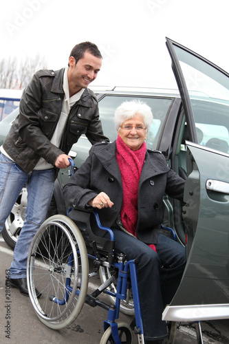 Photo: Young man assisting senior woman in wheelchair Young man assisting senior woman in wheelchair