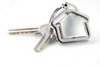 Photo: Two silver keys with metal house figure Two silver keys with metal house figure