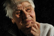 Reflecting, an elderly woman looks away, isolated Reflecting, an elderly woman looks away, isolated