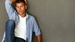 Video: Hansdome young man sitting on floor against grey background Hansdome young man sitting on floor against grey background