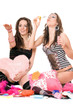Two happy girls blow bubbles. Isolated