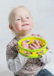 isolated portait baby playing tamborine
