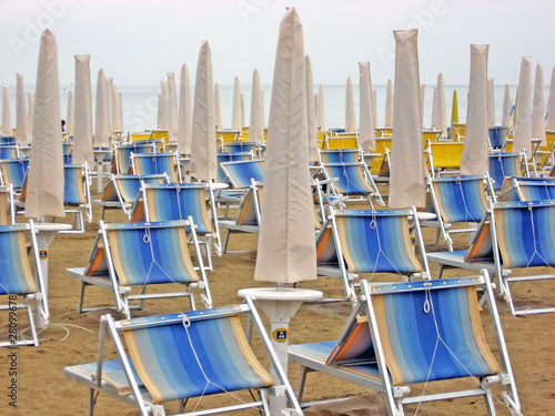 Photo: chairs and beach beds closed waiting for tourists chairs and beach beds closed waiting for tourists