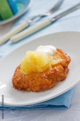 Photo: Potato latke topped with apple sauce and white sour cream Potato latke topped with apple sauce and white sour cream