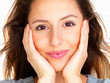 Pretty woman holding her face