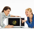 Photo: Smiling young couple preparing food in the kitchen Smiling young couple preparing food in the kitchen