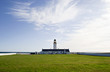 Lighthouse with Cloudy sky and Green Grass Lighthouse with Cloudy sky and Green Grass
