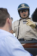 Highway patrol officer examines man's driving license