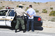 Police officer arrests male driver