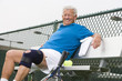 Man wearing knee band on tennis court