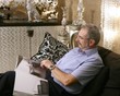 Senion man reading sofa luxury living room