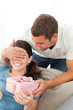 Happy woman receiving a gift from her boyfriend at home