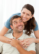 Portrait of a pretty woman hugging her husband on the sofa