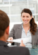 Happy businesswoman giving a paper to a colleague