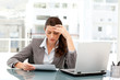Pensive businesswoman looking at a paper in her office