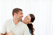 Lovely couple laughing together in the living room