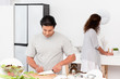 Hispanic couple preparing a salad together in the kitchen