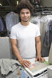 Portrait of young man working in dry cleaners