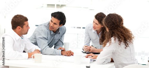 Photo: Four engineers discussing about a new project Four engineers discussing about a new project