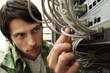 Man working on network switch, close-up.
