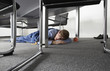 Man sleeping on floor under desk in boardroom