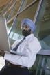 Serious Asian Businessman Using Laptop