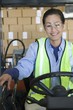 Cheerful Asian woman working in distribution warehouse