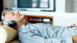 Relaxed senior man listening to music with headphone