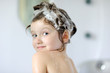 Photo: Small girl in bath with shampoo on her hair Small girl in bath with shampoo on her hair