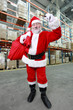 Photo: Santa Claus with red sack ringing in a bell in storehouse Santa Claus with red sack ringing in a bell in storehouse