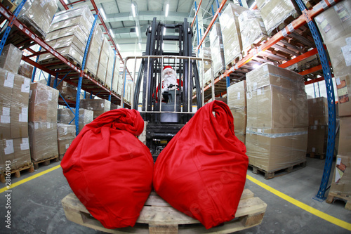 Photo: Santa Claus on forklift with two large red sacks - front Santa Claus on forklift with two large red sacks - front